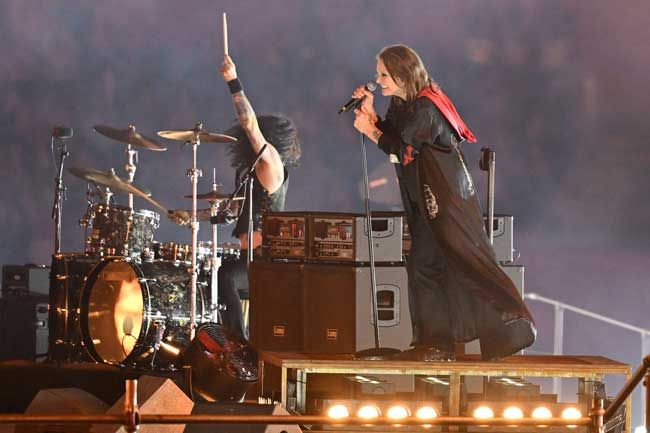Ozzy Osbourne dressed in black on stage