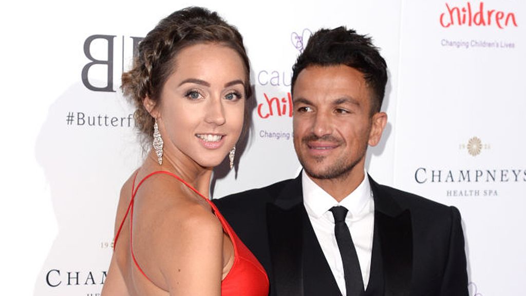 Emily Andre wearing a red floor-length gown and Peter Andre in a black suit at a Caudwell Children's event in 2019. 