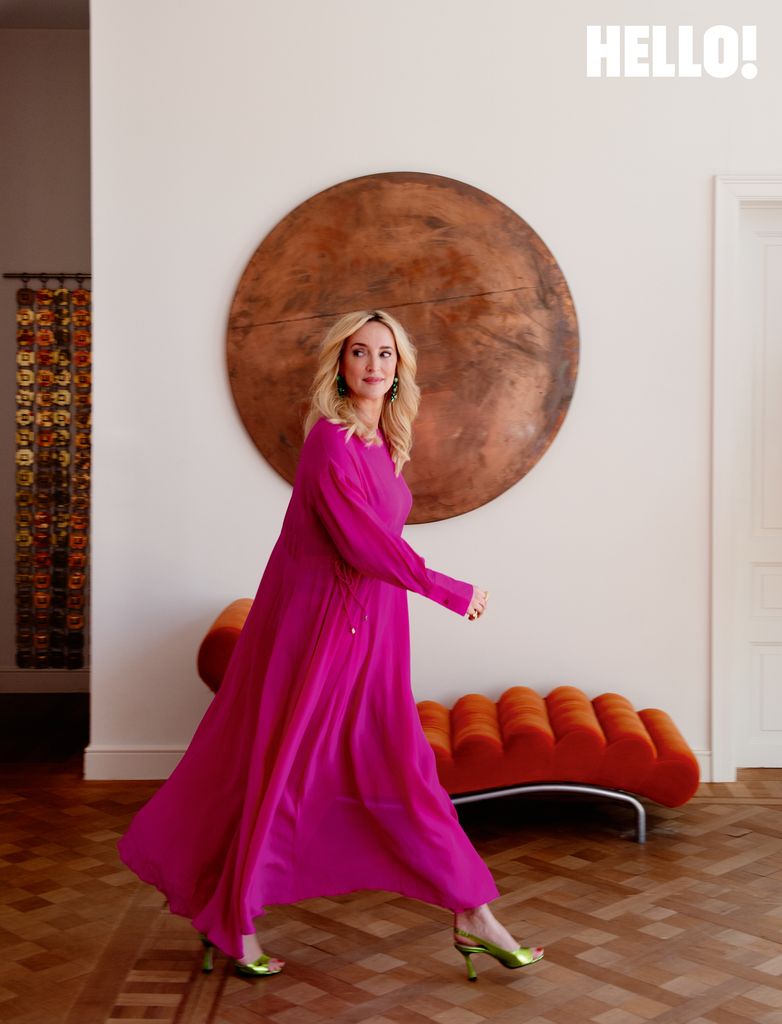 Inge strides past an Italian modernist-style organic ''backbone'' daybed  in the three-storey apartment in Antwerp’s Graanmarkt Square