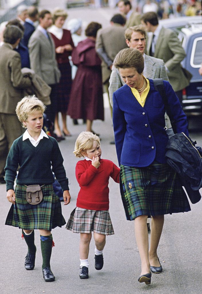 Princess Anne wearing matching tartan skirt with Zara and son Peter in a kilt