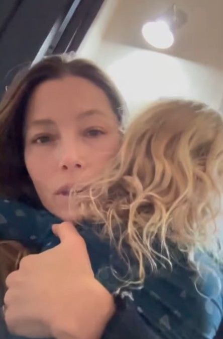 Jessica Biel cradling son Phineas with long blonde curly hair 