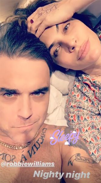 robbie williams and ayda field posing in bed