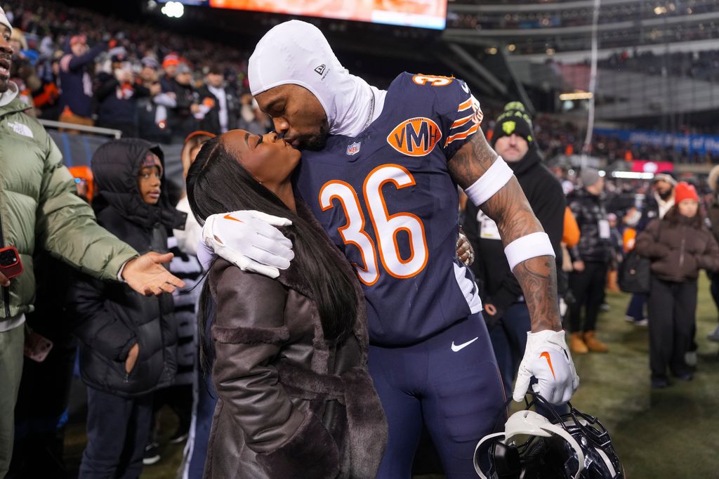 Jonathan Owens #36 of the Chicago Bears and Simone Biles kiss before an NFL football Wild Card game against the Green Bay Packers at Solider Field on January 10, 2026 in Chicago, Illinois.