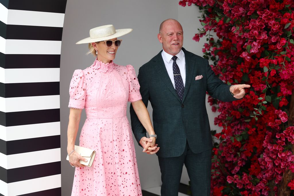 A photo of Mike and Zara Tindall walking hand in hand in Australia