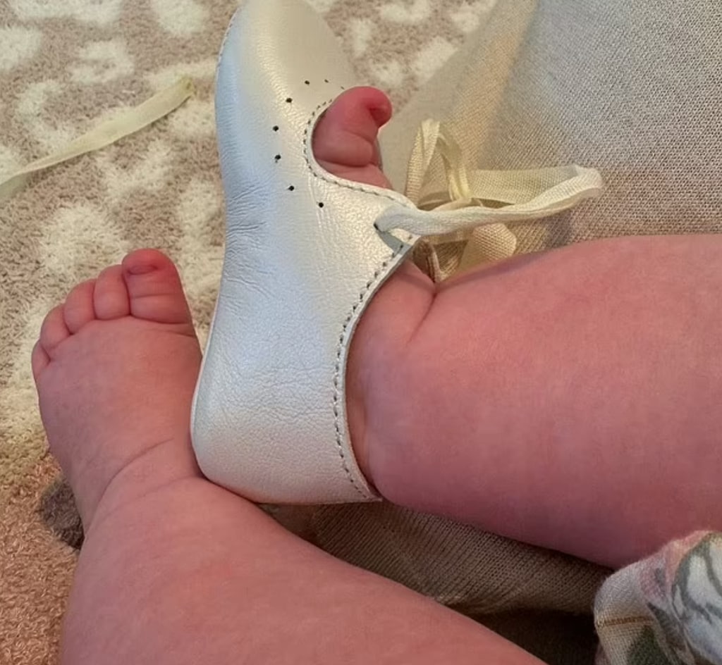 Eloise's little toes seen peeking out of her booties