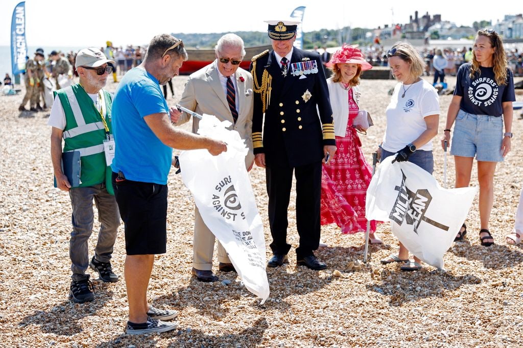 King Charles III participates in a coastal clean-up 