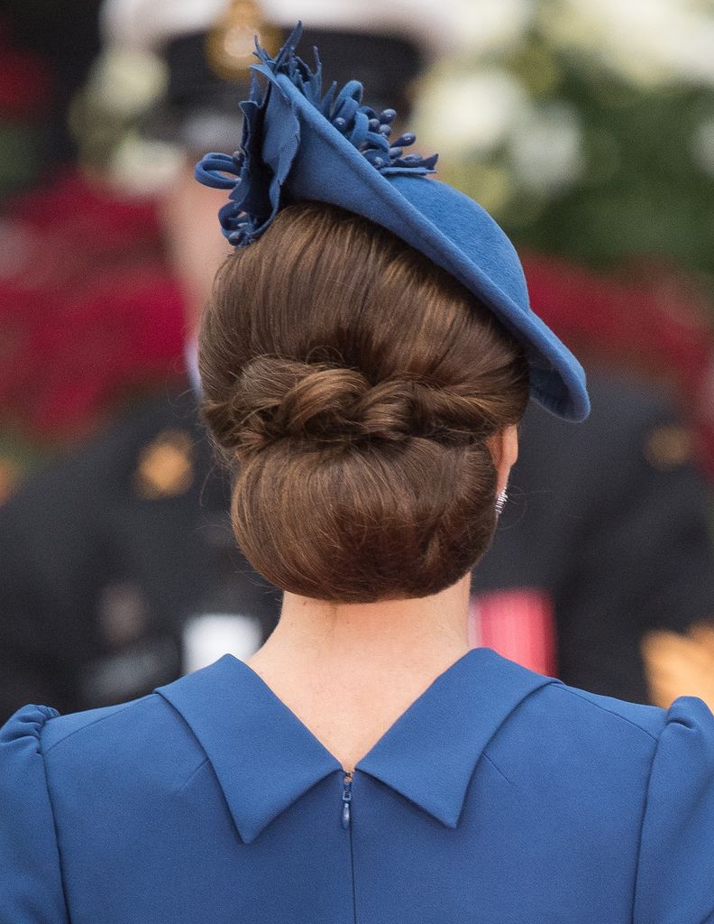 Kate Middleton's hair in a bun with loops worn underneath a blue hat