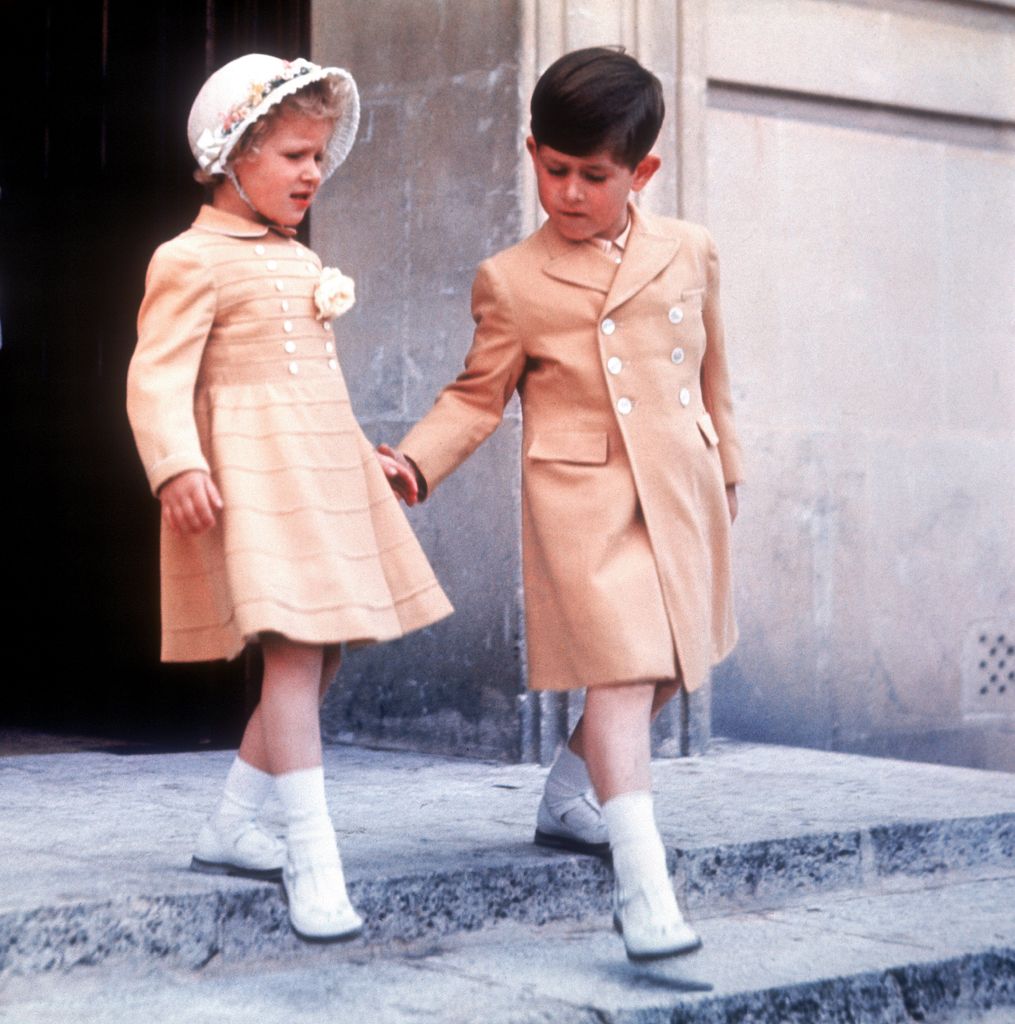 Young Princess Anne walking with young King Charles