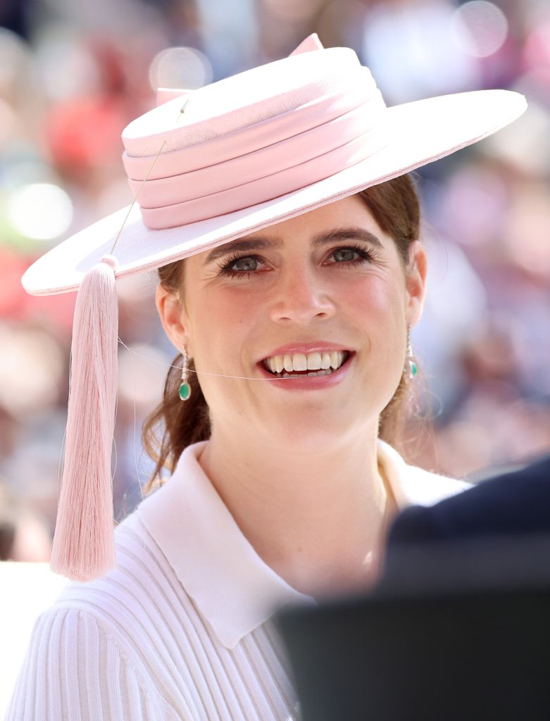 Princess Eugenie wearing pink hat and emerald earrings
