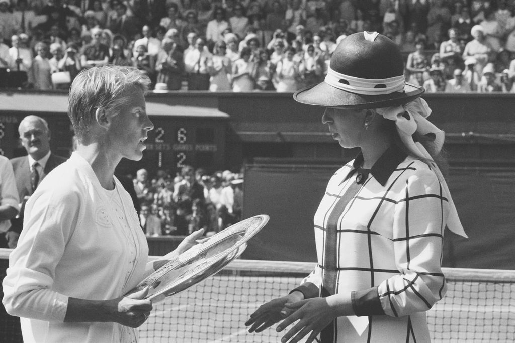 Princess Anne wearing a striped outfit with large hat and chatting with tennis player Ann Jones after she won the Ladies Singles Finals at Wimbledon in 1969