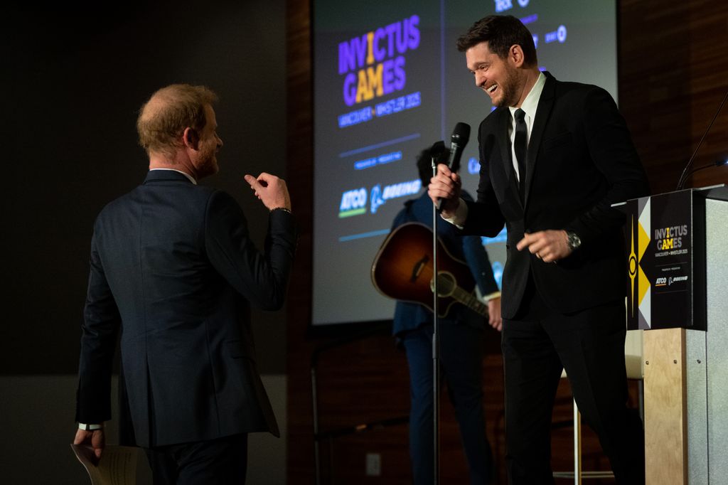 Prince Harry, the Duke of Sussex walks to the stage after Canadian signer and songwriter, Michael Buble's performance during the "One Year to Go" Invictus Games dinner