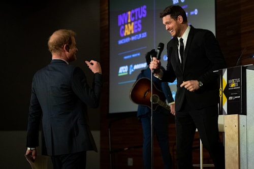 Prince Harry, the Duke of Sussex walks to the stage after Canadian signer and songwriter, Michael Buble's performance during the "One Year to Go" Invictus Games dinner