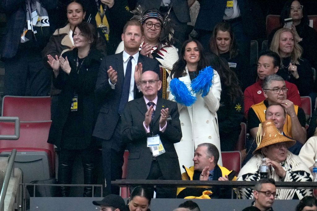 Prince Harry and Meghan Markle applauding