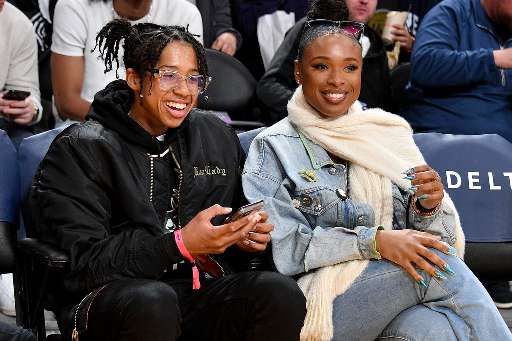 Jennifer Hudson and her son David Otunga Jr. sit side by side at Lakers game