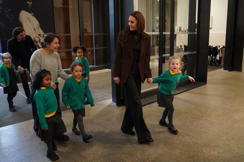 princess kate walking into gallery with group of school children