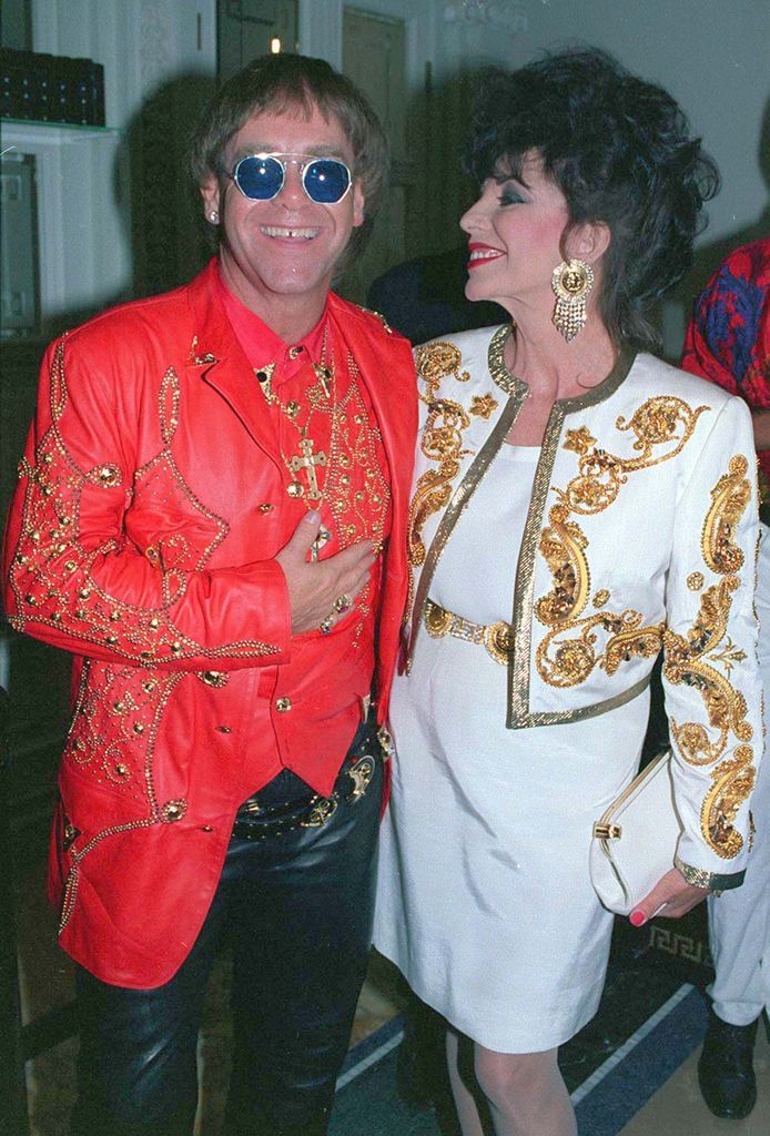 Elton John with Joan Collins at the opening of Italian designer Gianni Versace 's shop in London on May 28, 1992