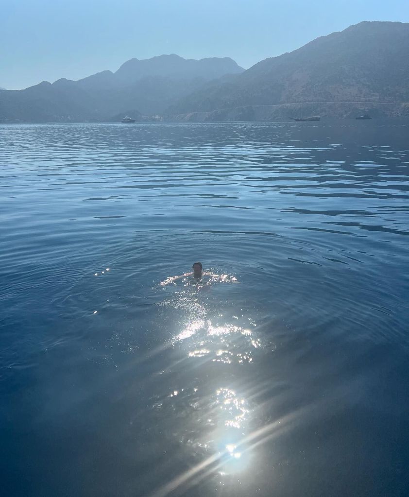 man swimming in sea 