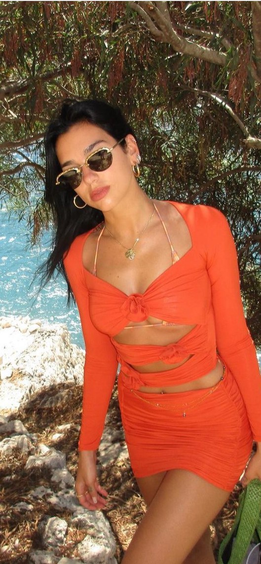 Dua lipa in cut out orange dress in albania 