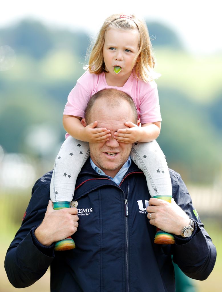 Mia Tindall covering Mike Tindall's eyes while riding on his shoulders