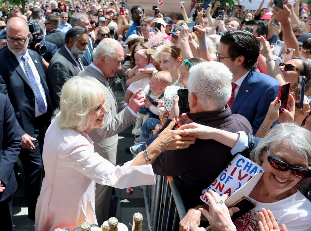 Charles and Camilla shake hands with public at Landsdowne Park