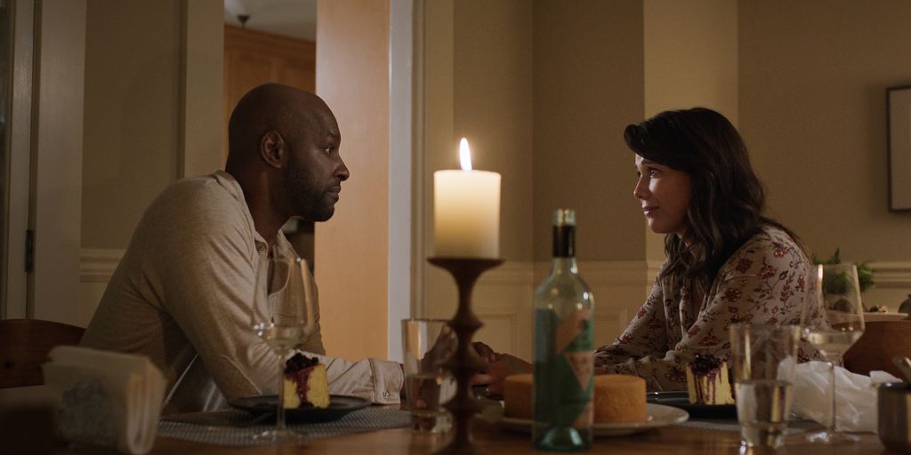Preacher and Paige sit at a table in still from season five