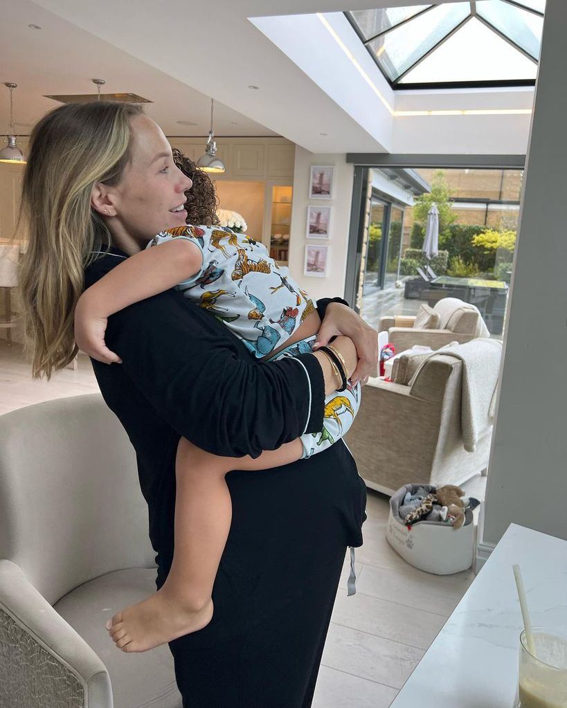 Kate Ferdinand holds her son Cree at their home