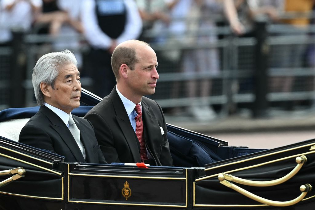 Prince William and Japan's Head of the Official Suite, Hirofumi Nakasone, travel in a Semi-State Landau Carriage during the state visit
