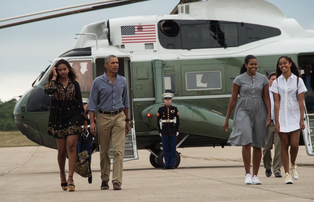 US President Barack Obama, First Lady Michelle Obama and daughters Malia and Sasha walk to board Air Force One at Cape Cod Air Force Station in 2016