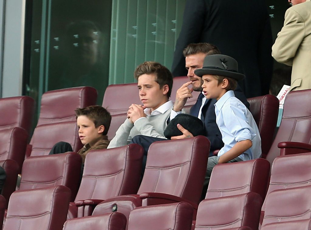 Brooklyn watching Arsenal with his father and brothers in 2013