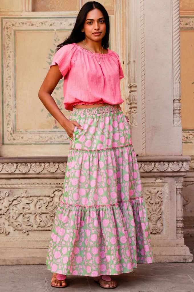 woman in floaty pink skirt and top