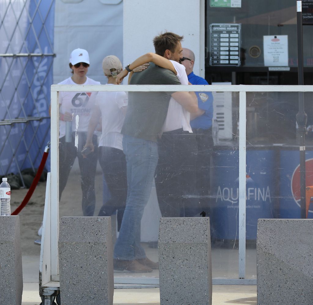 When Jennifer finished the run, John greeted her with a big hug