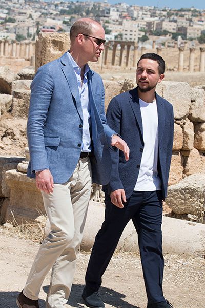 Prince William and Prince Hussein walking through ruins