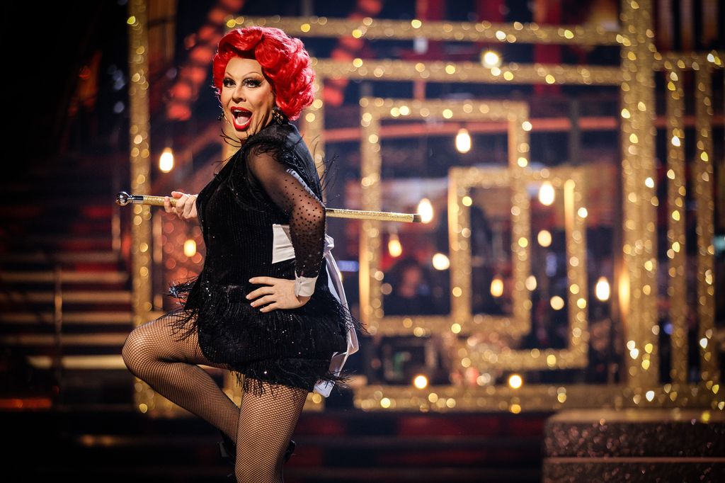 dancer on dance floor holding cane