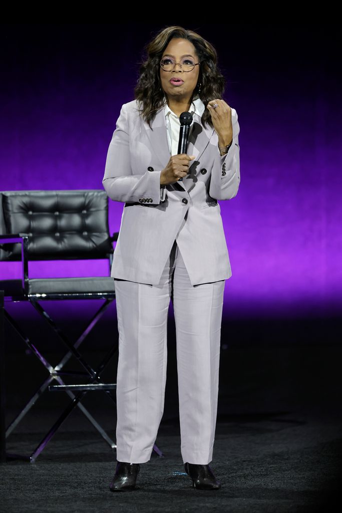 Oprah Winfrey shows off her slimmed down figure in a belted co-ord at the Louis  Vuitton show