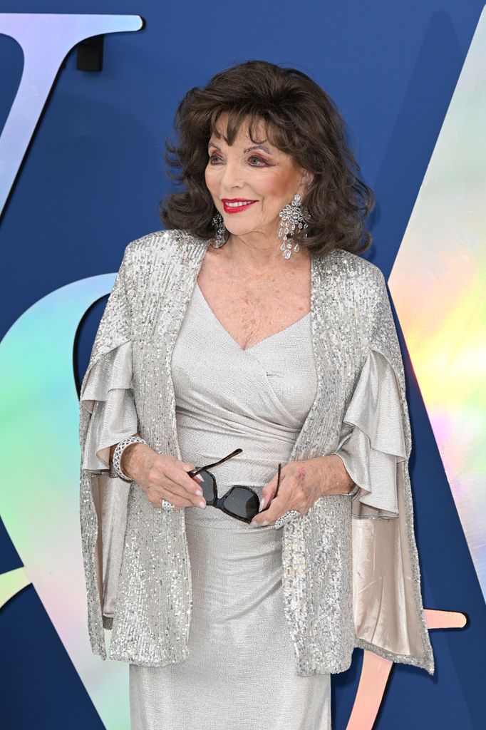 health Joan Collins smiling to left in silver dress