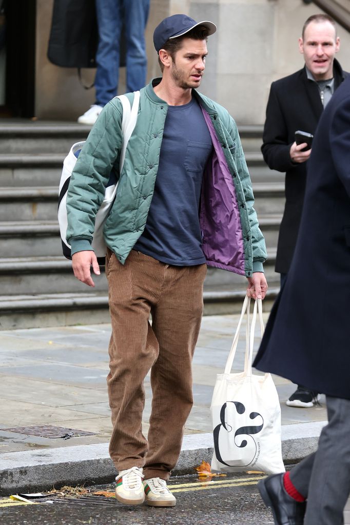 Andrew Garfield in casual clothing walking in London