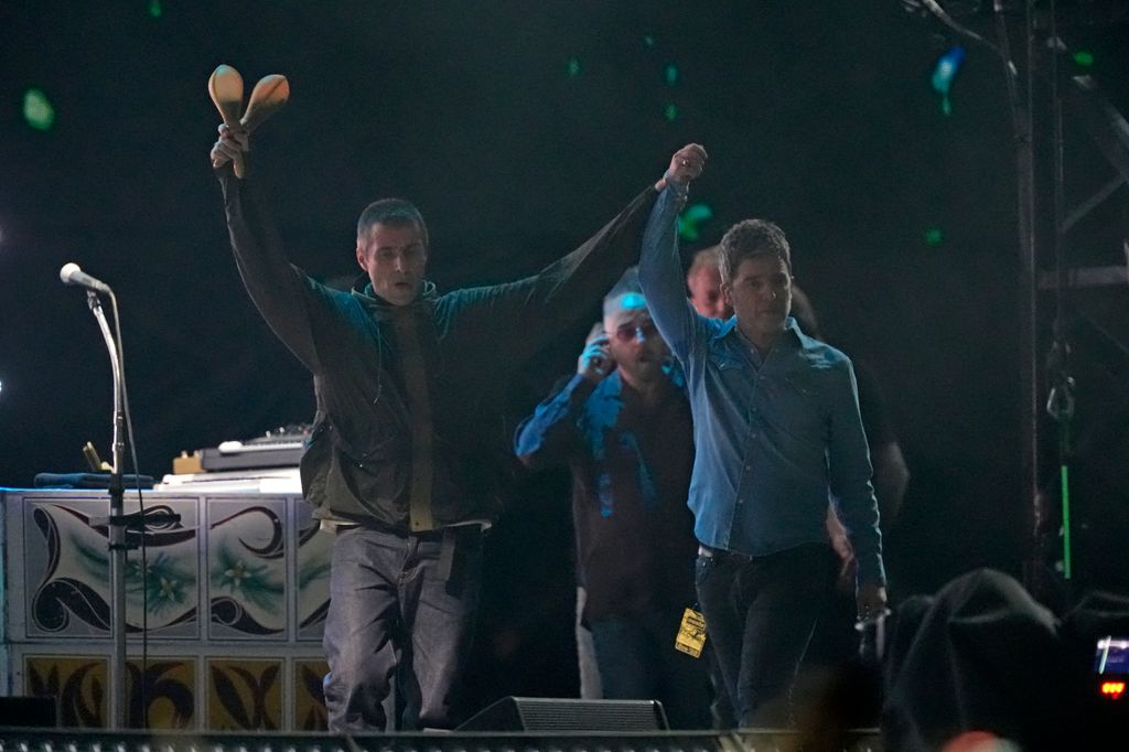 Liam and Noel Gallagher onstage at the Principality Stadium in Cardiff, July 2025