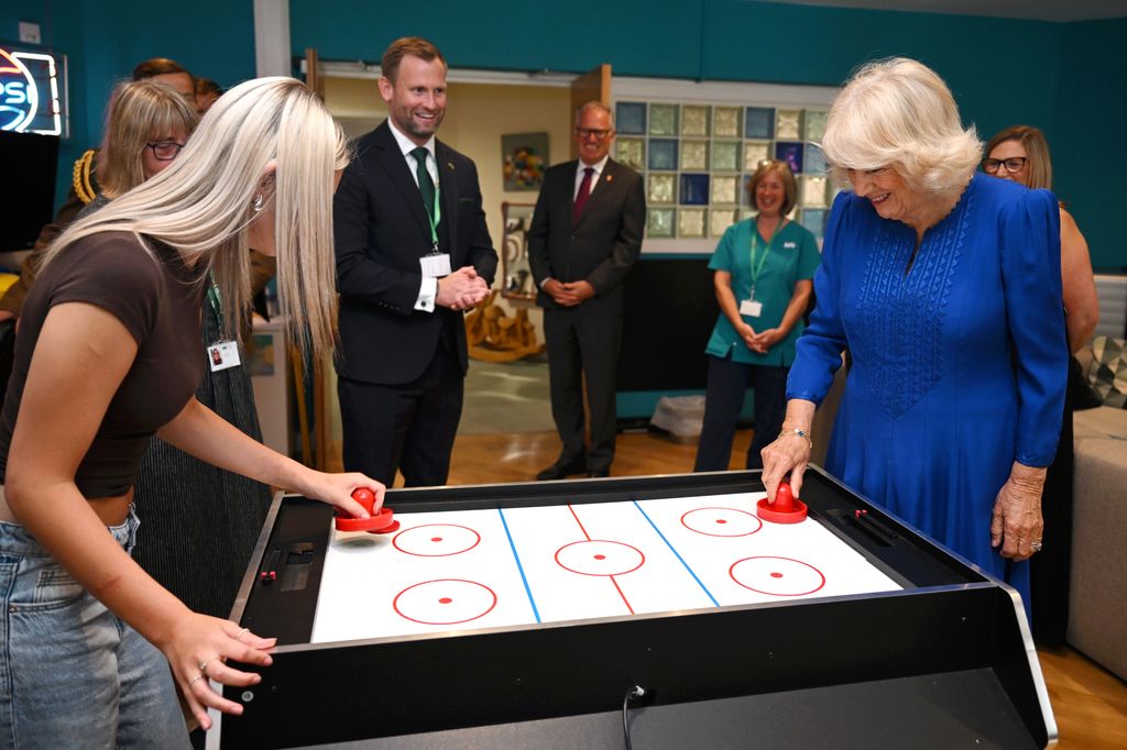 The Queen enjoyed a game of air hockey