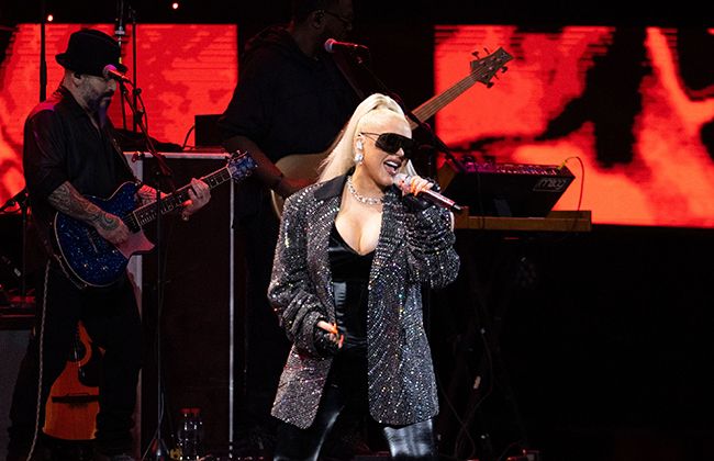 christina aguilera performing in chile in low cut bodysuit and sparkly grey blazer