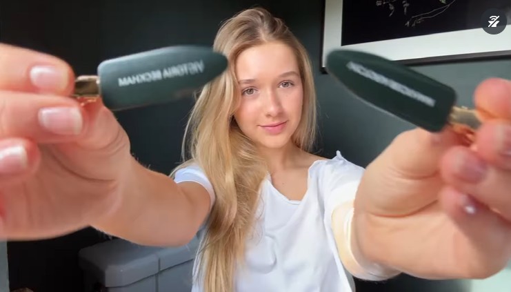 Harper holding hair clips up to camera