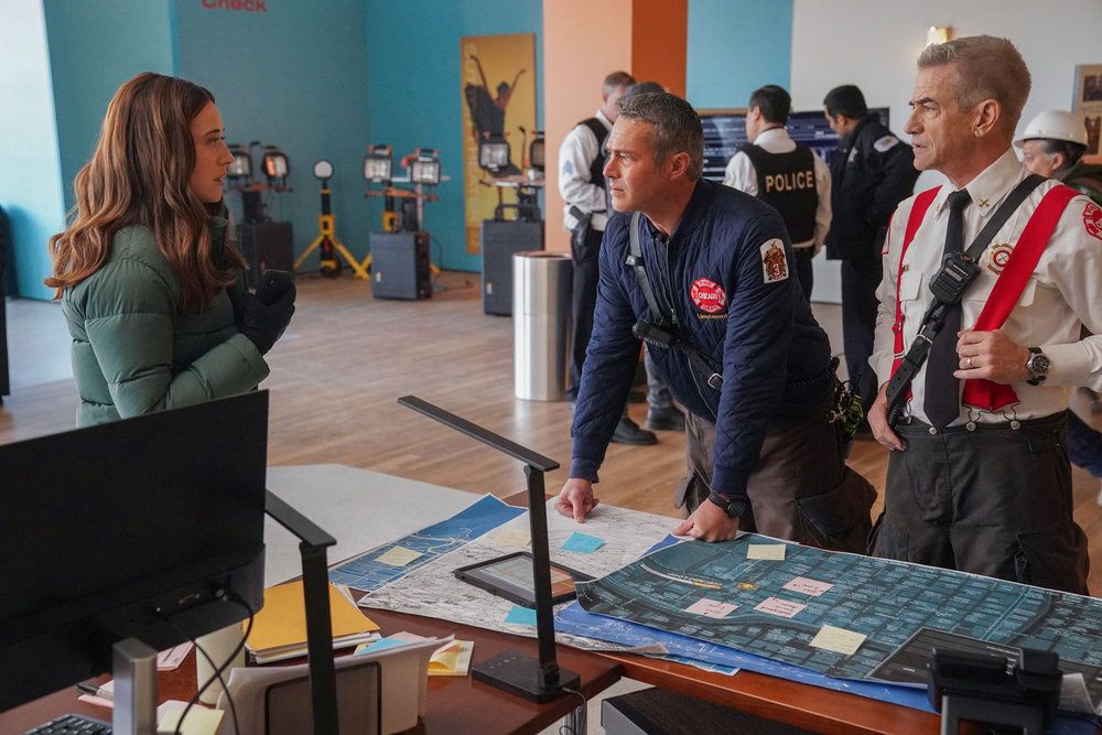 Marina Squerciati as Officer Kim Burgess, Taylor Kinney as Kelly Severide, Dermot Mulroney as Chief Dom Pascal in Chicago PD episode 12x14-