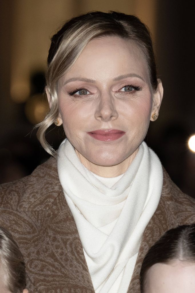 Princess Charlene close up wearing white scarf