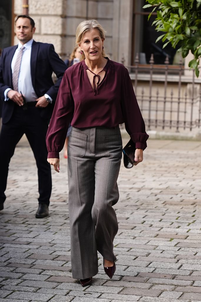 The Duchess of Edinburgh in grey trousers and burgundy blouse