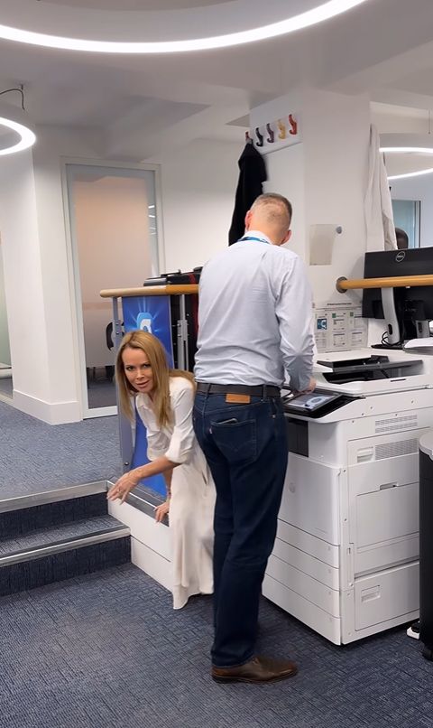 Amanda Holden dodging a man at a photocopier