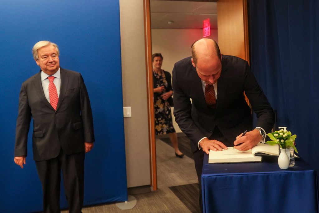Prince William, Prince of Wales signs a book while meeting with United Nations (UN) Secretary-General 