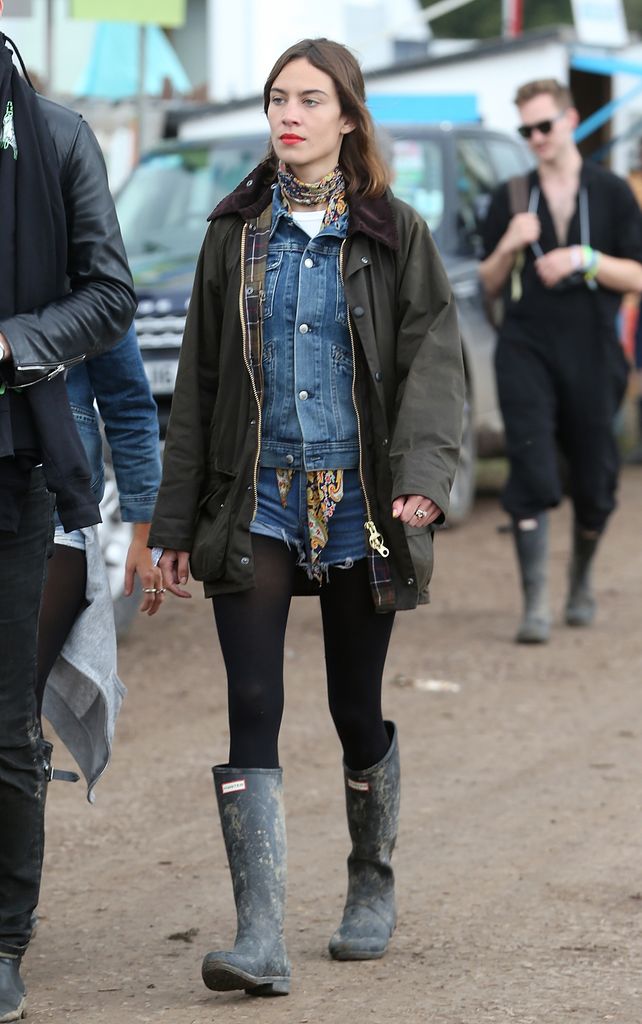 Alexa Chung at the Glastonbury Festival at Worthy Farm, Pilton on June 28, 2015  in a denim jacket and shorts, tights and wellington boots