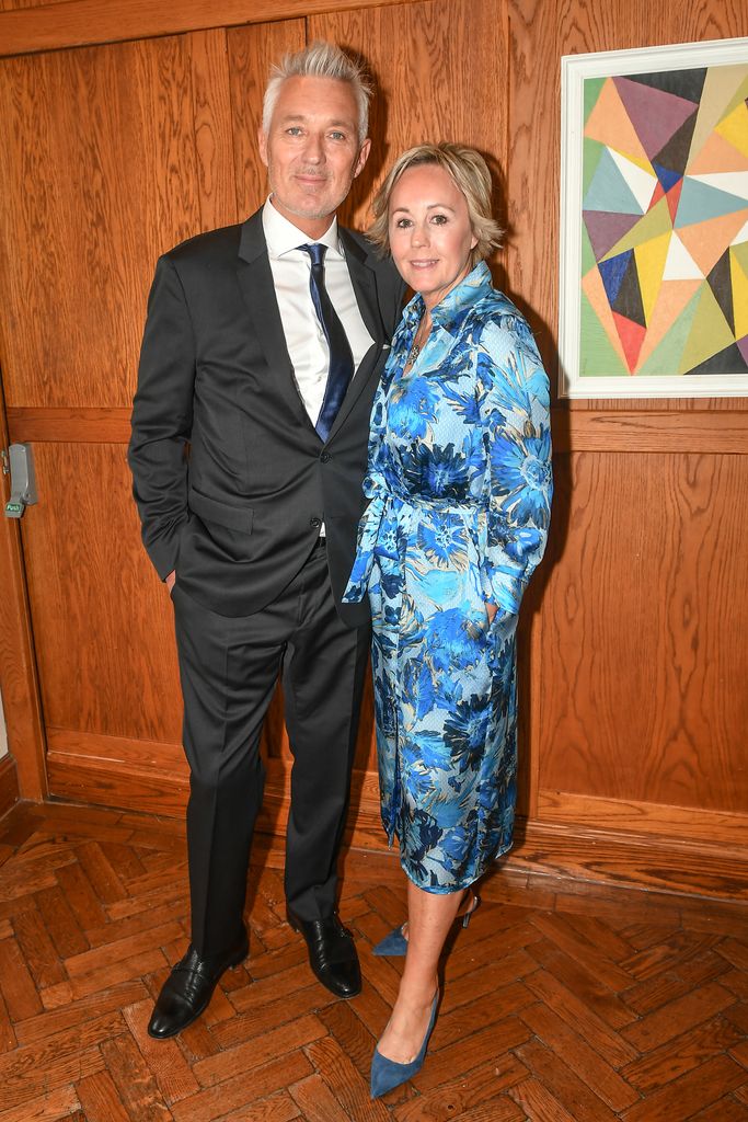 Martin Kemp in a suit and Shirlie Kemp in a blue floral dress
