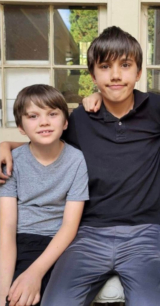 Pictured with his brother smiling 