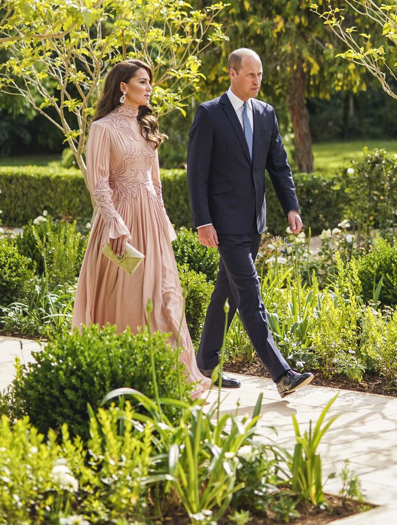 kate walking through garden in blush gown beside william in suit