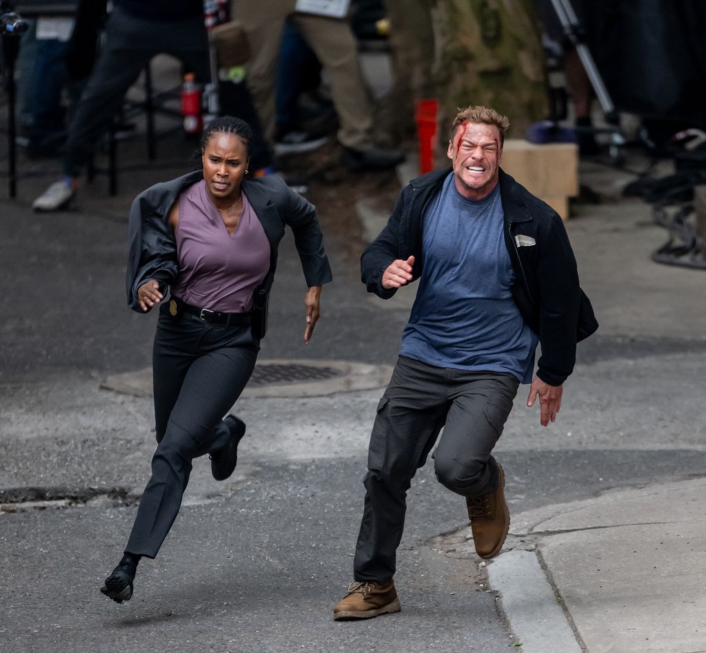 Alan Ritchson and Sydelle Noel are seen filming scenes of the Amazon Prime Video TV series "Reacher" season 4 on June 18, 2025 in Philadelphia, Pennsylvania
